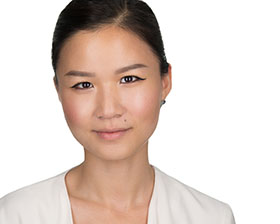 Team member corporate headshot with subtle approachable smile