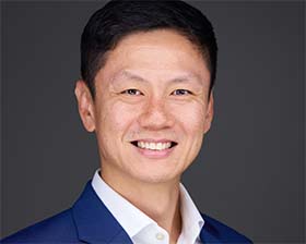 Professional LinkedIn headshot on a clean grey background